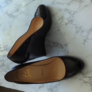 Black patent leather Christian Louboutins barely warn